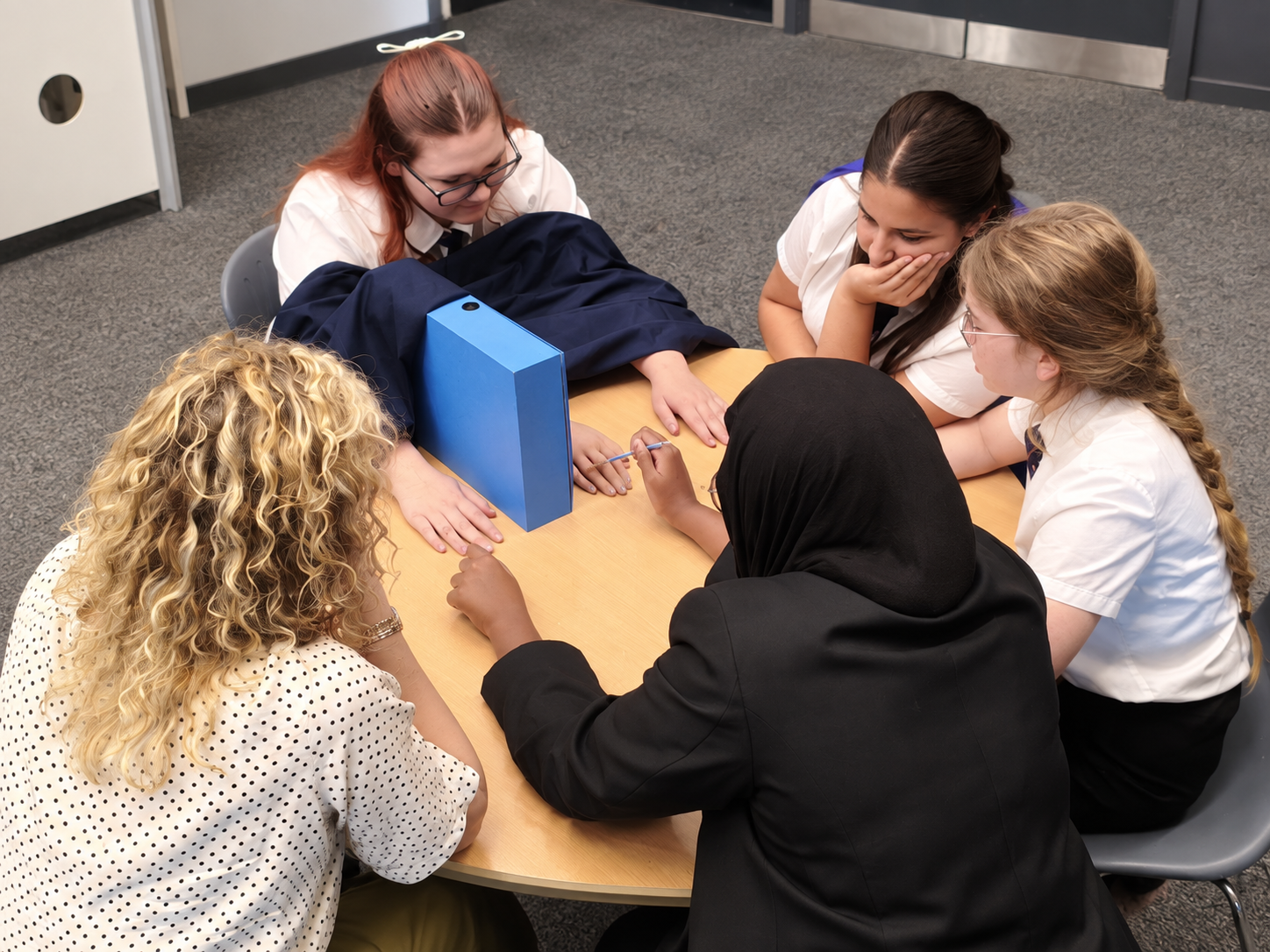 Students try the rubber hand illusion in a workshop.